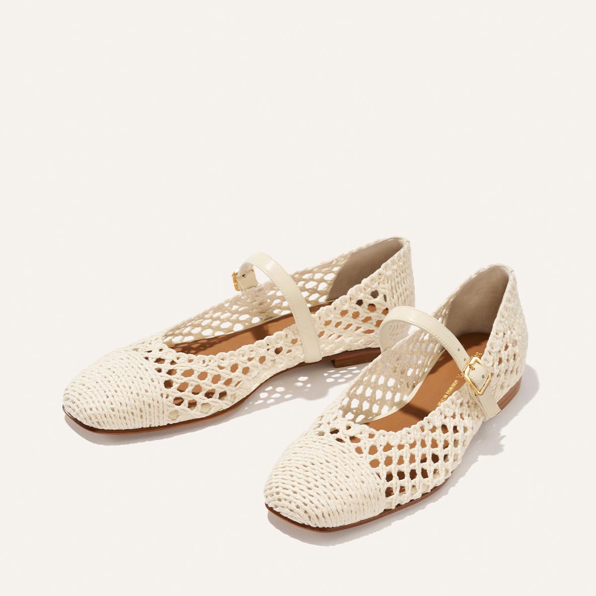 The Fonteyn Jane - Ecru Macrame by Margaux: cream cotton macrame Mary Jane flats with pointed toes, low heels, mesh sides, and a gold-buckle strap, shown on a light background.