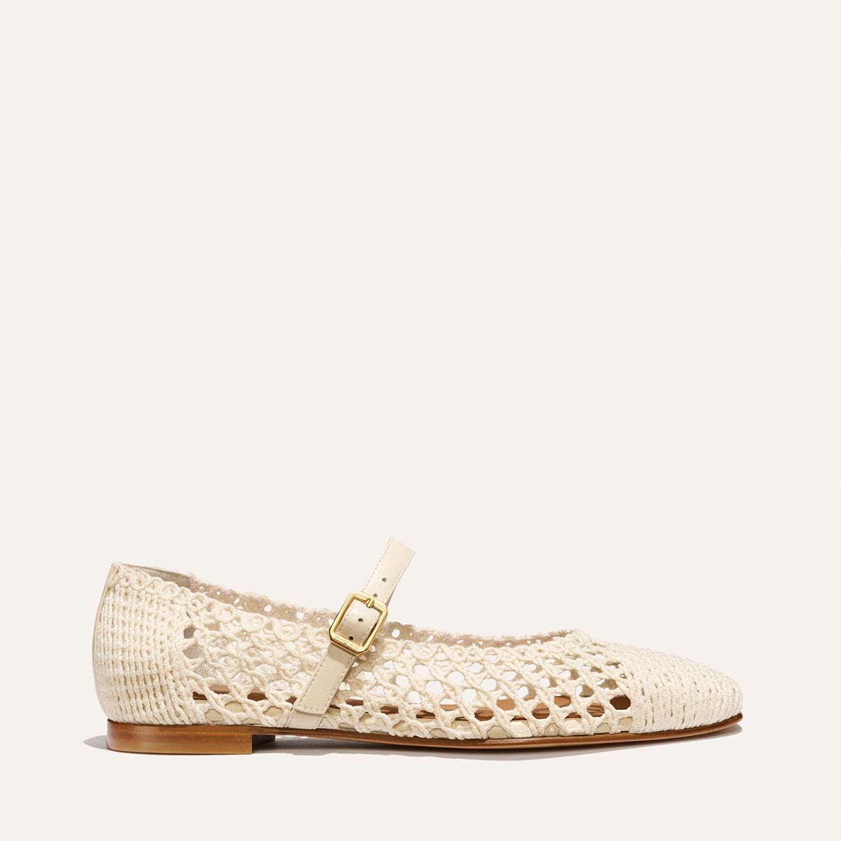 The Fonteyn Jane - Ecru Macrame by Margaux: a cream cotton macrame pointed-toe ballerina flat with a low brown sole and adjustable cream strap with gold buckle, shown on a simple light background.