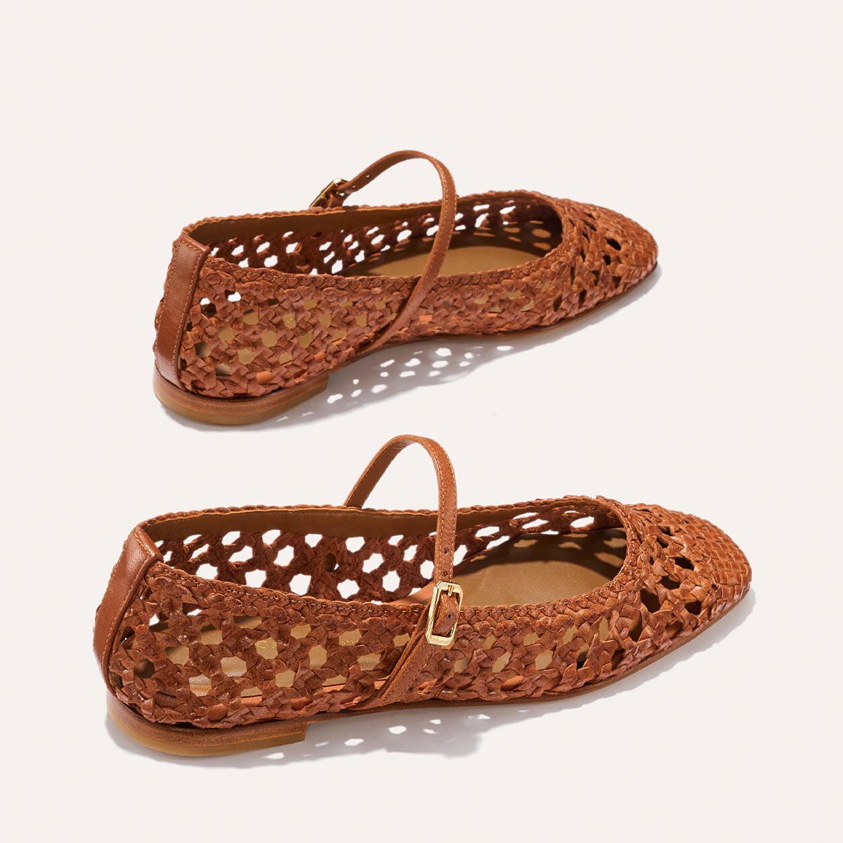 The Fonteyn Jane - Saddle Woven Leather flats by Margaux feature handwoven brown leather, a pointed toe, adjustable strap, airy cut-outs, and flat soles, shown against a plain light background.