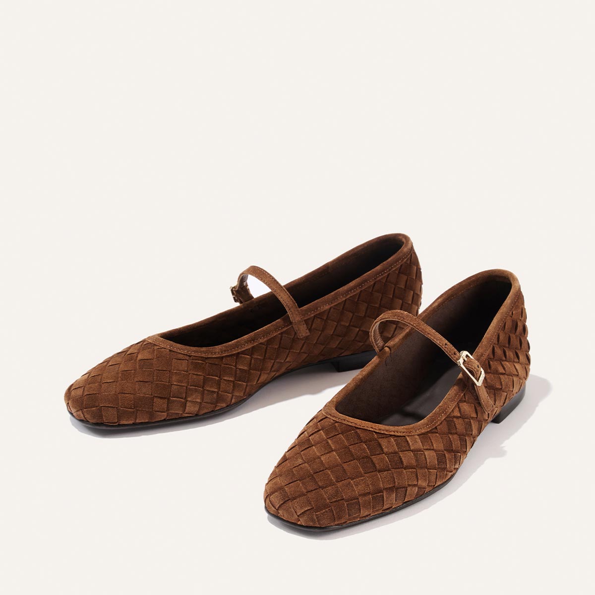 The Fonteyn Jane by Margaux in Saddle Woven Pasado Suede, a pair of brown Mary Jane flats featuring a single strap and buckle, is displayed on a plain white background.
