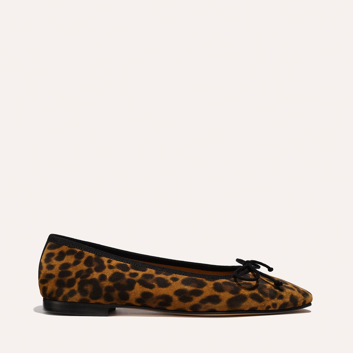 The Fonteyn - Leopard Suede by Margaux: a single leopard-print ballet flat with black trim, rounded toe, small black bow, and low black heel shown on a neutral background.