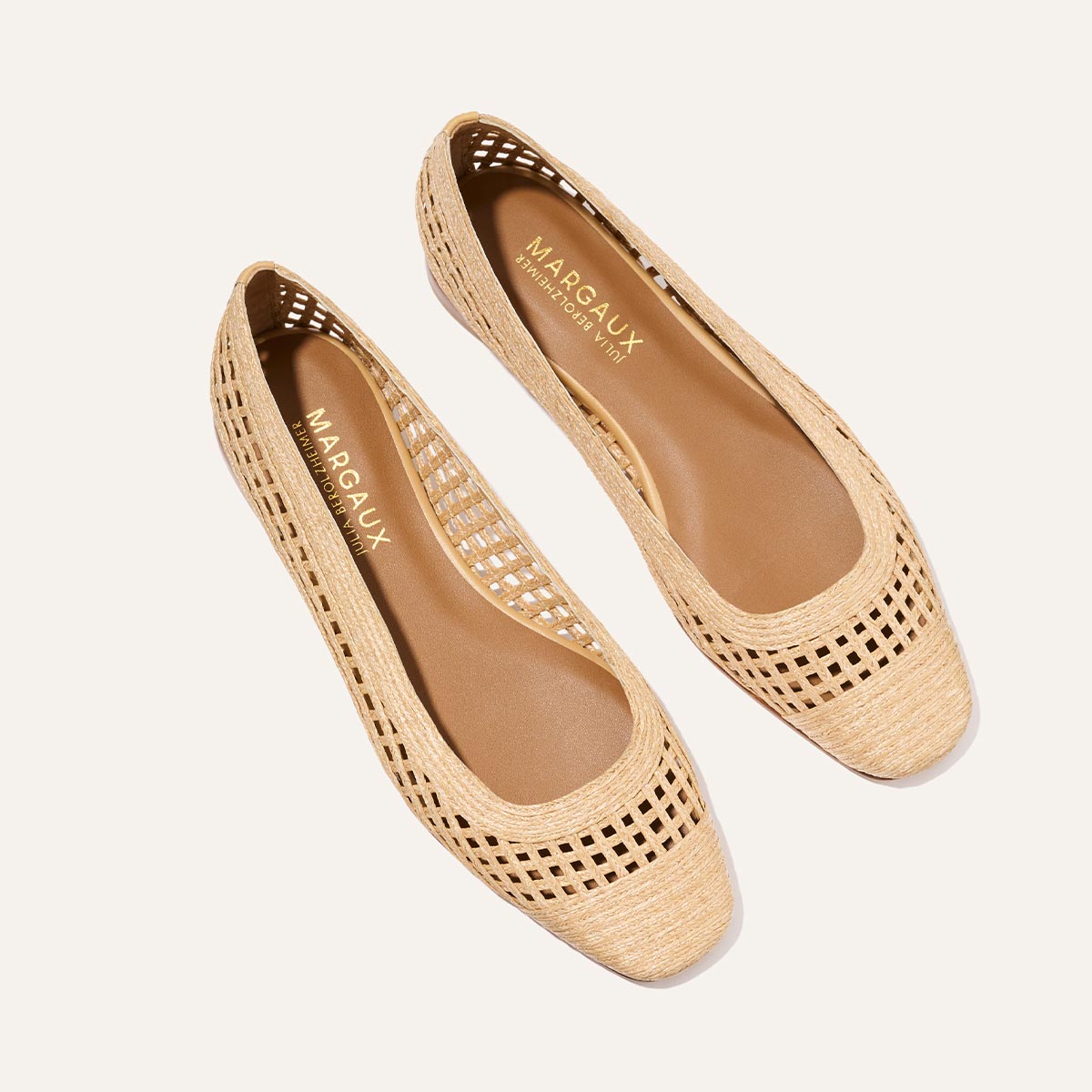 The Fonteyn - Natural Grid Raffia by Margaux are beige woven flats with square toes and perforated sides, featuring Margaux's gold branding on the insole—ideal for adding elevated style to your daily outfits.