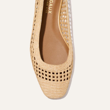 A close-up of Margaux’s The Fonteyn - Natural Grid Raffia sandal, showcasing a tan woven lattice upper, square toe, and cushioned brown insole—an ideal pick for playful yet elevated style.
