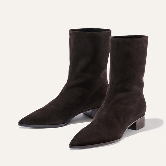 A pair of The Hayes Boot in dark chocolate suede by Margaux, featuring pointed toes and low block heels, displayed on a light background.