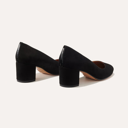 The Heel in Black Suede, a classic block heel featuring a sleek almond toe design complemented by a comfortable 2.5-inch heel.