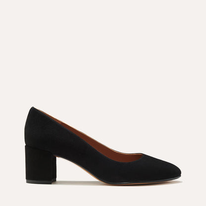 The Heel in Black Suede, a classic block heel featuring a sleek almond toe design complemented by a comfortable 2.5-inch heel.