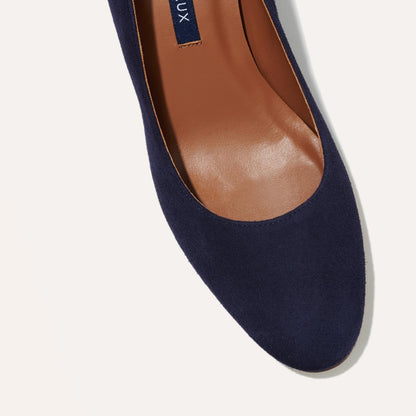 The Heel in Midnight Suede, a classic block heel featuring a sleek almond toe design complemented by a comfortable 2.5-inch heel.