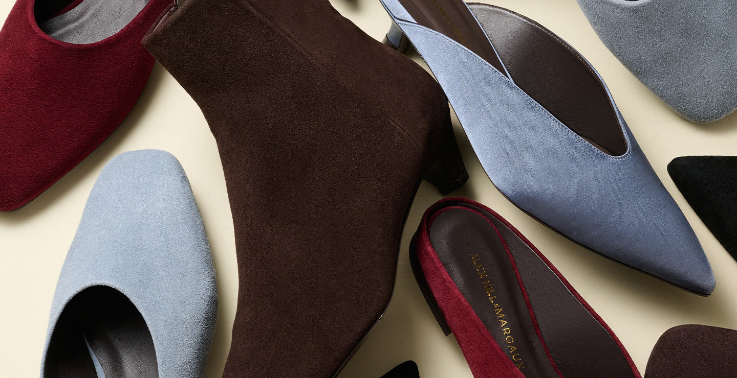 Collection of women's pointed-toe shoes in various colors on a light background