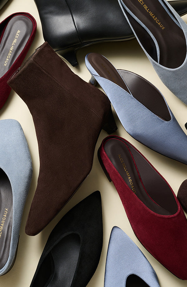 Collection of women's shoes in various colors on a light background