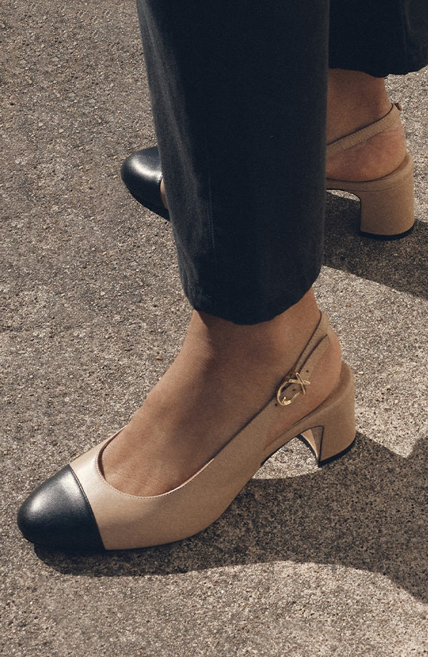 Woman wearing cap toe cluny slingback shoes