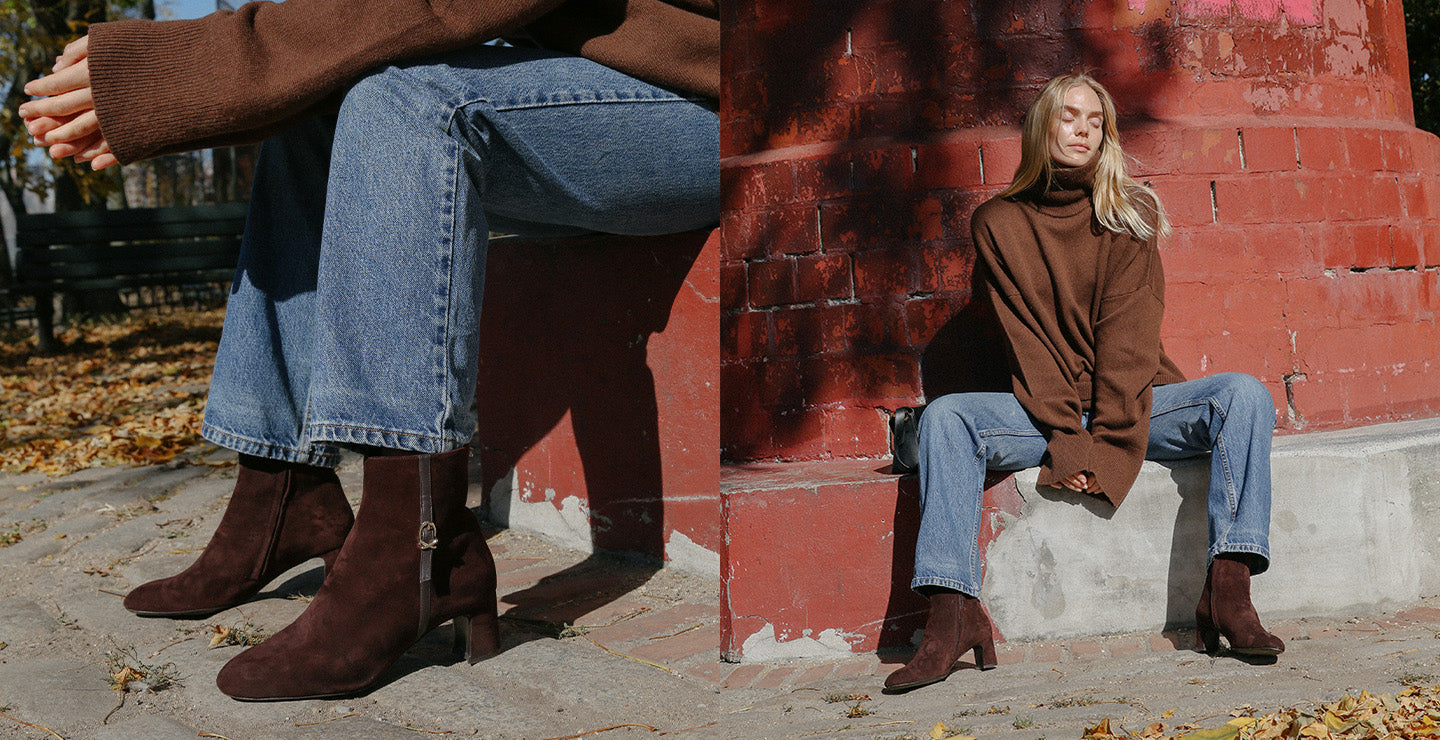 The Bowery Boot in rich chocolate suede, an ankle boot featuring an elegant breasted heel and gold-tone buckle hardware.