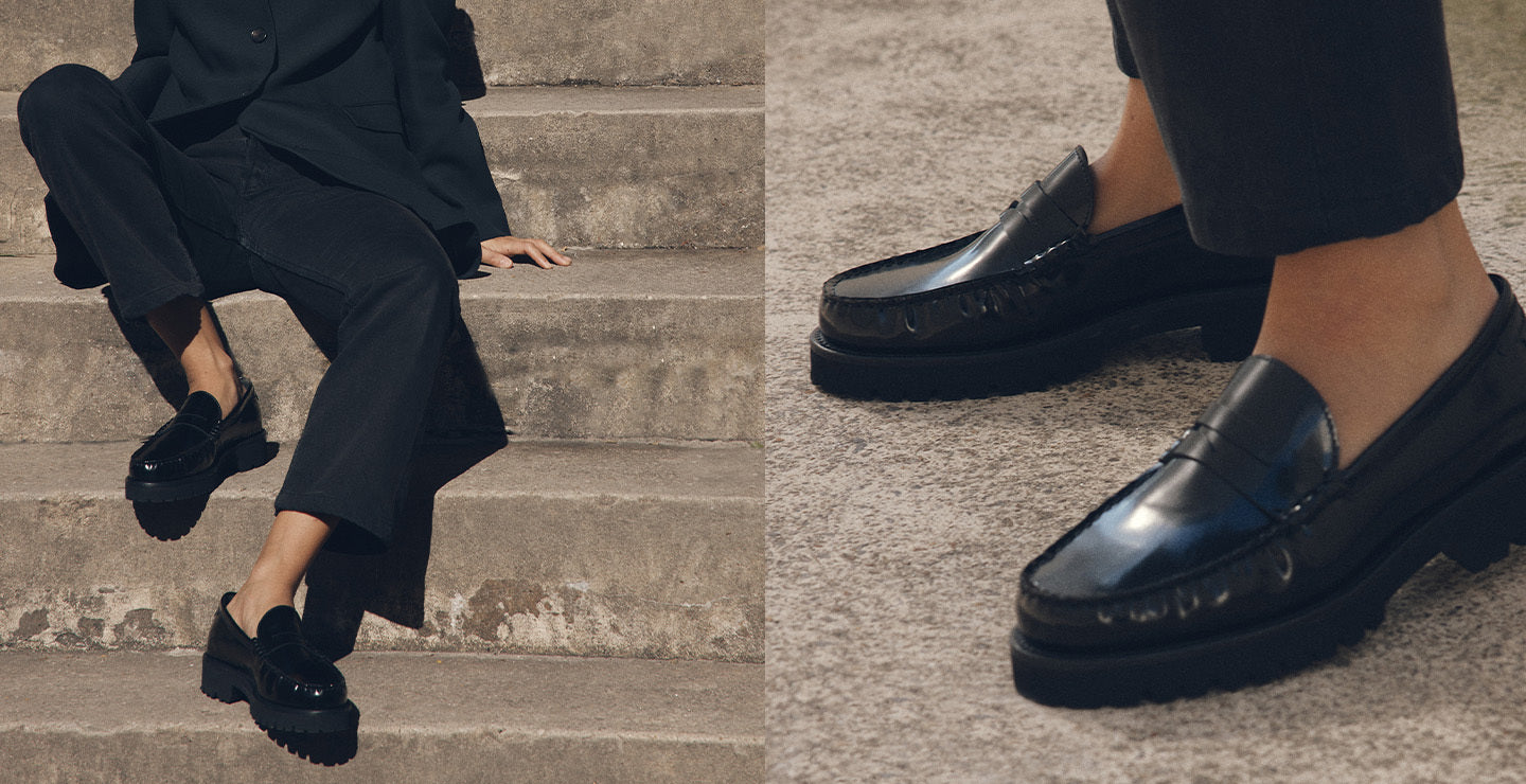Person wearing black loafers sitting on steps, with a close-up of the shoes.