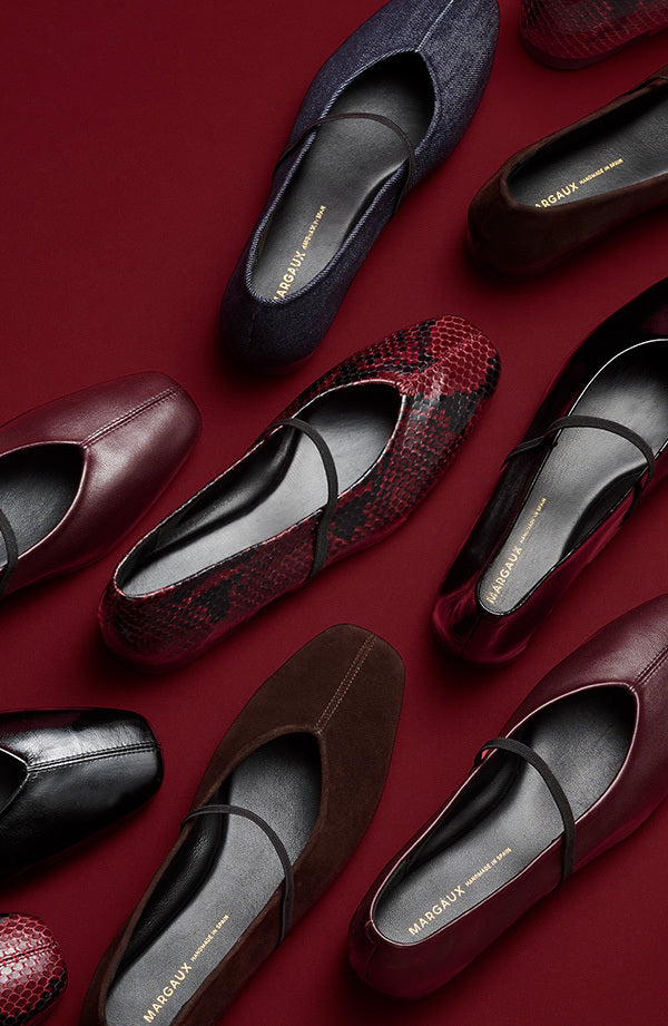 Various women's flats on a red background
