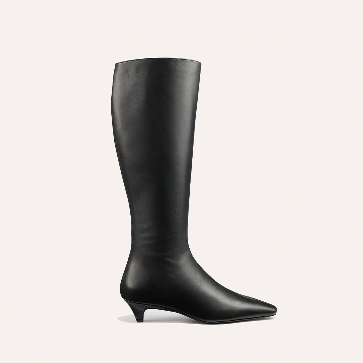 The Imogen - Black Calf by Margaux is a black, knee-high leather boot with a pointed toe and low, angled heel, displayed in profile against a plain light background.