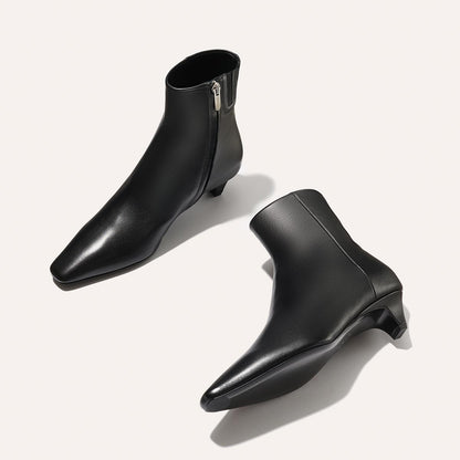 The Alex Mill x Margaux: The Inga - Black Calf from margaux-development are sleek black kitten heel boots with a side zipper and short heels, ideal for chic city strolls.