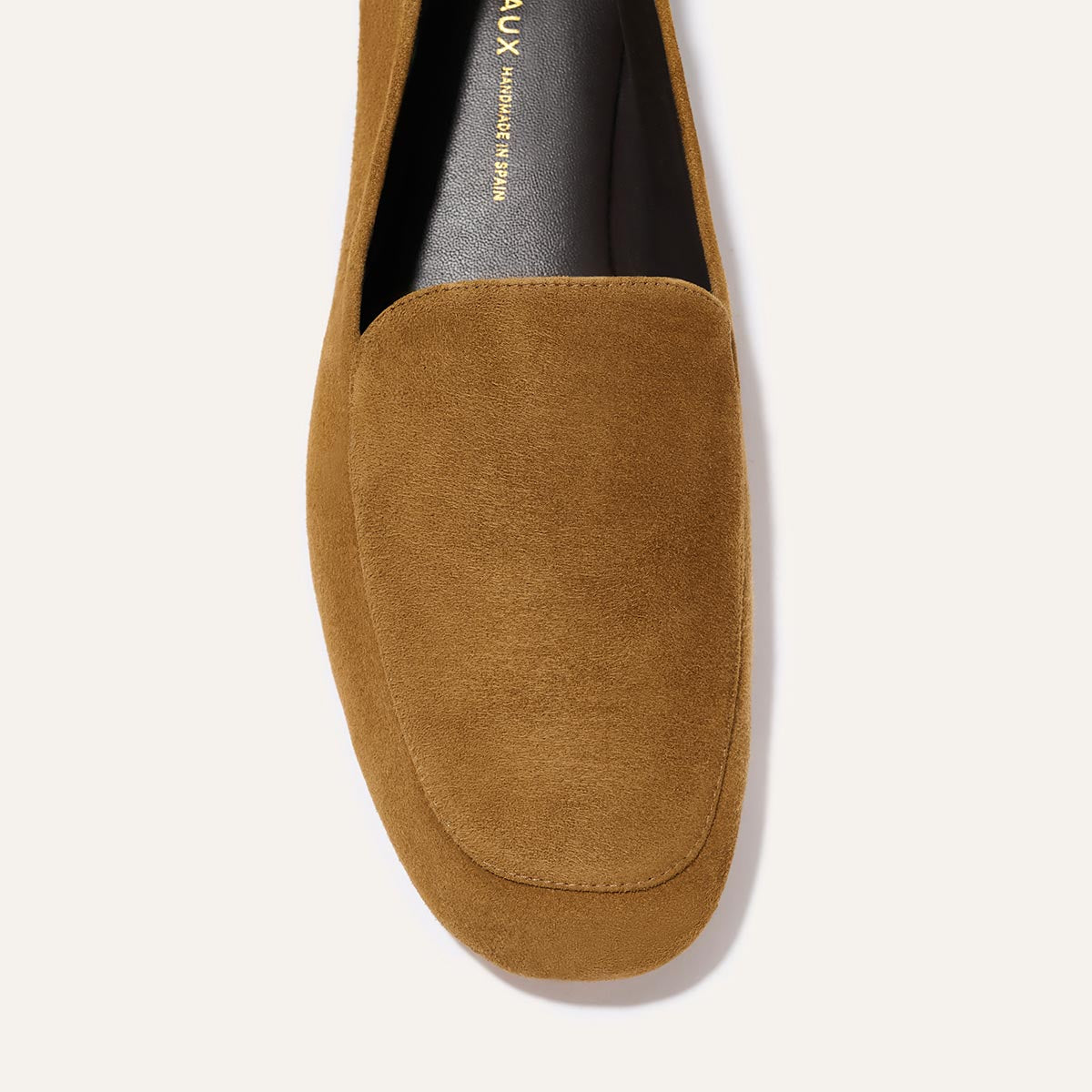 A top-view close-up of Margaux’s The James Loafer in Cedar Suede, featuring a rounded toe, minimal stitching, and partial views of the insole and upper.