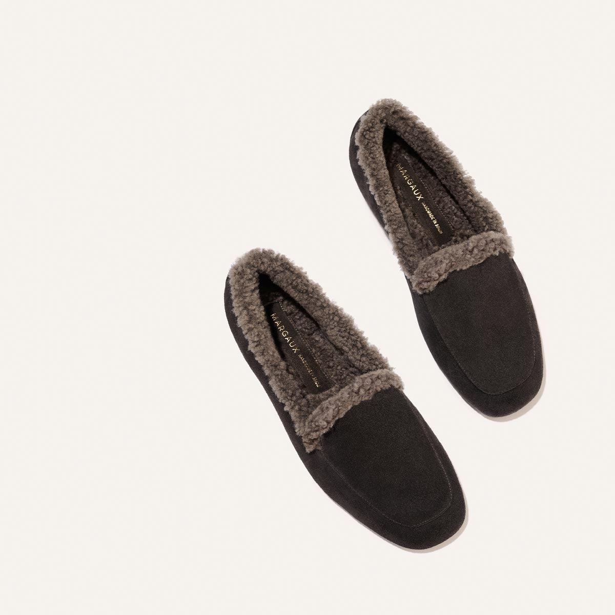The James Loafer - Dark Chocolate Suede and Shearling, a pair of handmade dark brown suede loafers lined with grey shearling, crafted using sacchetto construction.