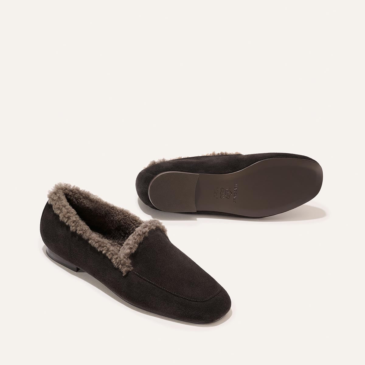 The James Loafer - Dark Chocolate Suede and Shearling, shown from the side and the sole.