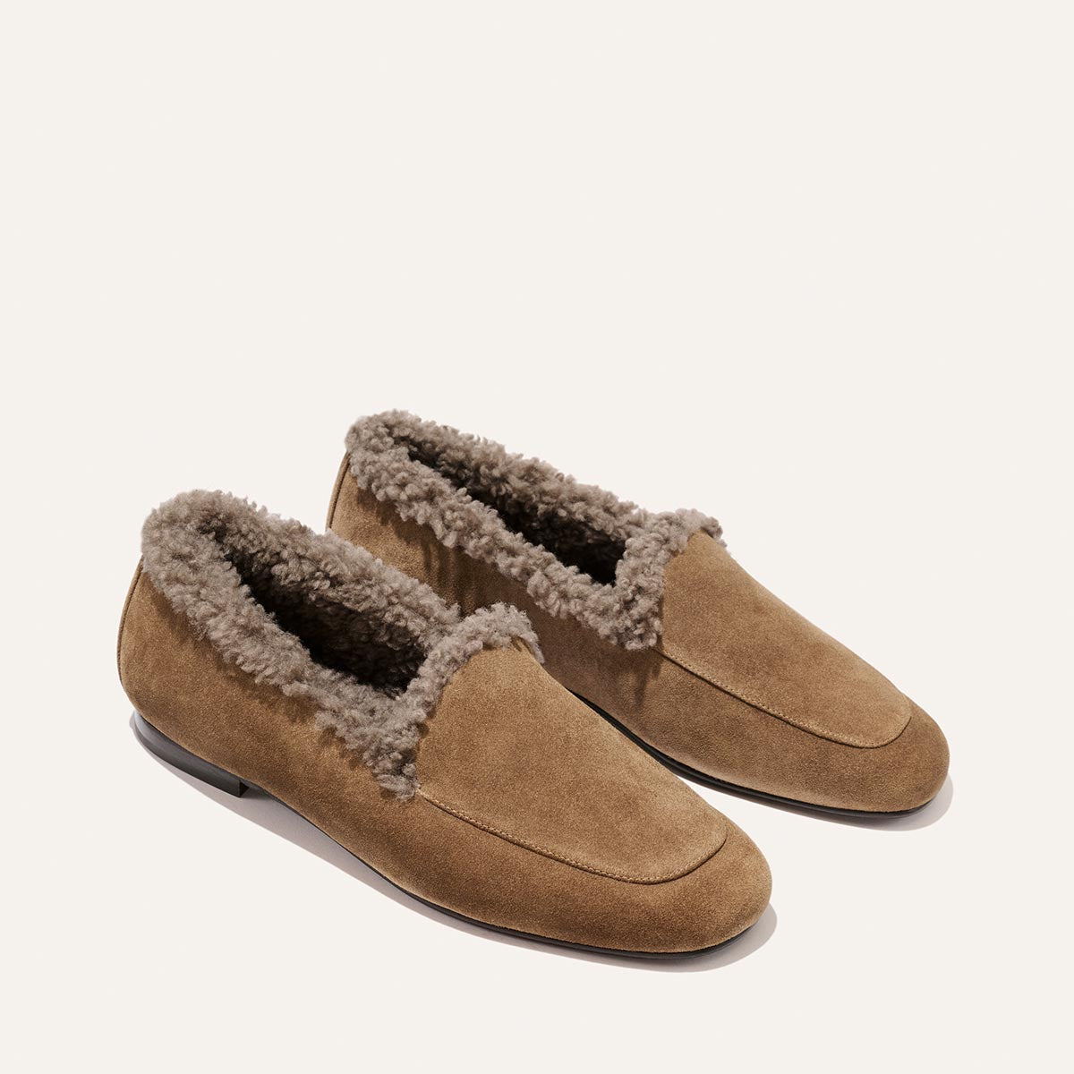 The James Loafer - Driftwood Suede and Shearling features a handmade tan suede exterior and a comfortable gray shearling lining.
