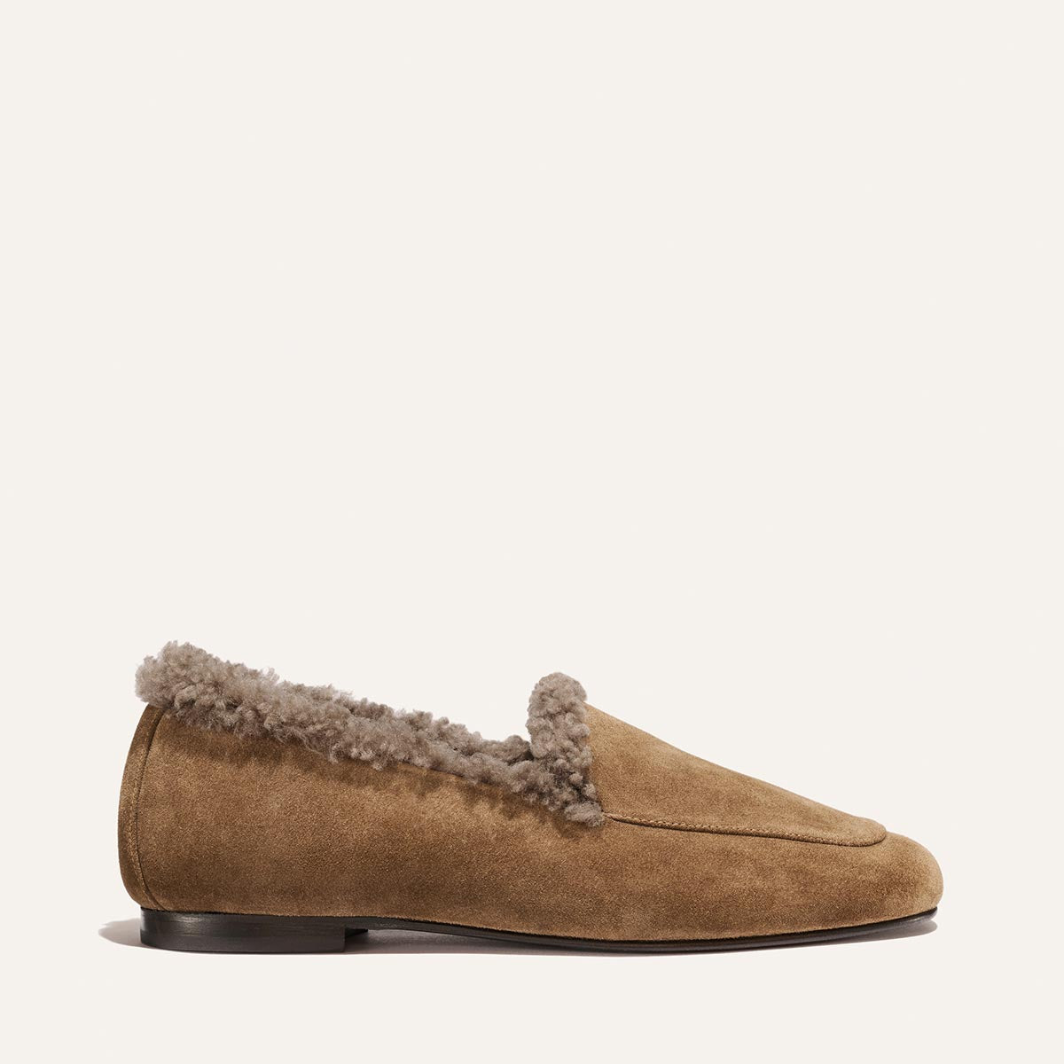 The James Loafer in driftwood suede, a handmade brown loafer lined with grey shearling.