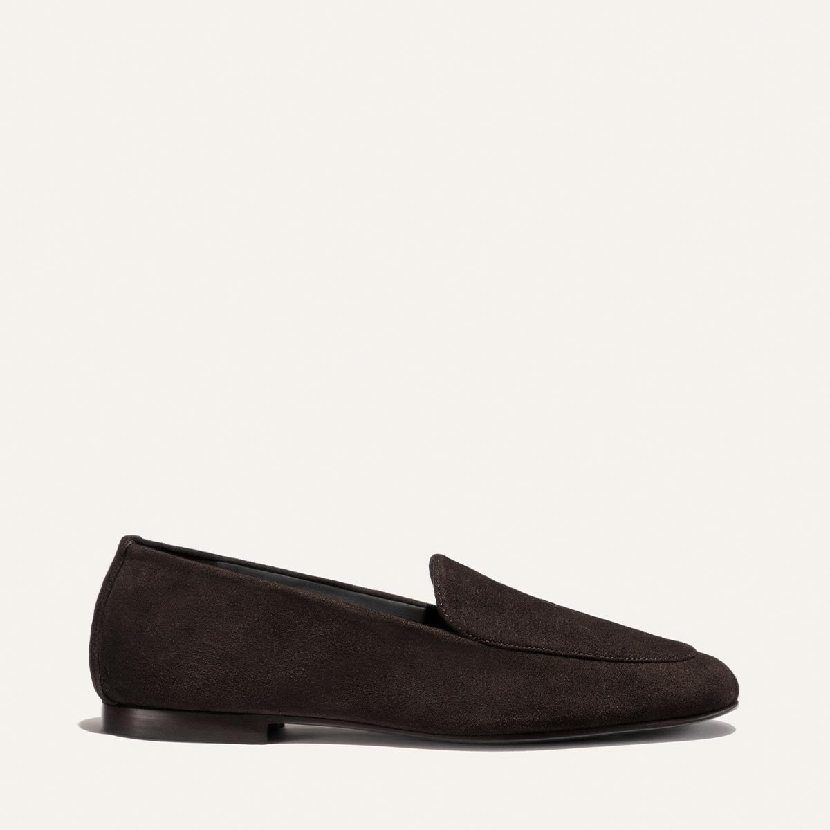 A single James Loafer in Molasses Suede by Margaux is displayed on a plain, light background, highlighting its slipper-like comfort and refined craftsmanship.