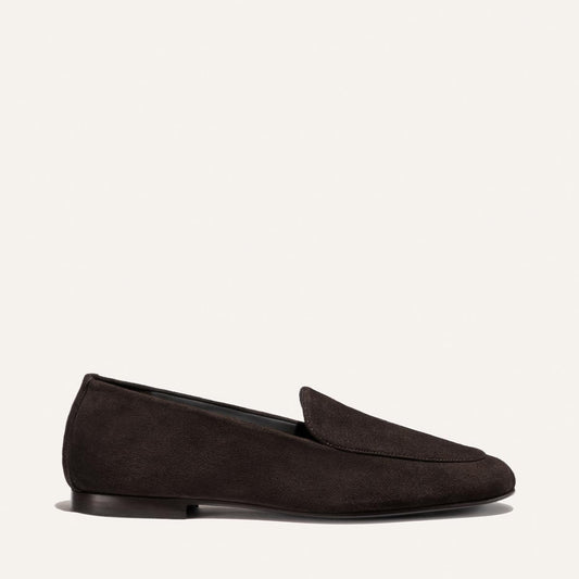 A single James Loafer in Molasses Suede by Margaux is displayed on a plain, light background, highlighting its slipper-like comfort and refined craftsmanship.