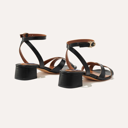 The Lena Sandal in Black Nappa, featuring perfectly placed straps around the ankle and toes and a comfortable 1.5-inch block heel.