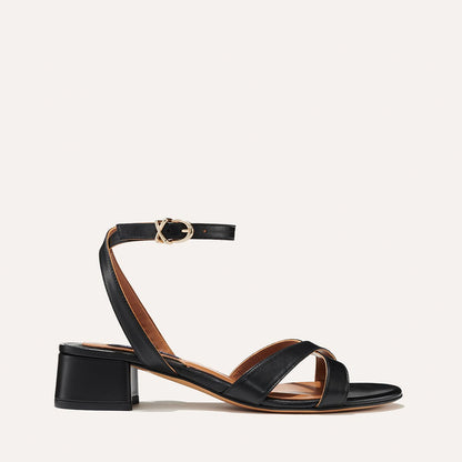 The Lena Sandal in Black Nappa, featuring perfectly placed straps around the ankle and toes and a comfortable 1.5-inch block heel.
