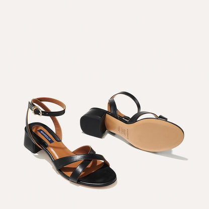 The Lena Sandal in Black Nappa, featuring perfectly placed straps around the ankle and toes and a comfortable 1.5-inch block heel.