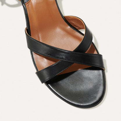 The Lena Sandal in Black Nappa, featuring perfectly placed straps around the ankle and toes and a comfortable 1.5-inch block heel.