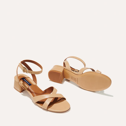 The Lena Sandal in Dune Nappa, featuring perfectly placed straps around the ankle and toes and a comfortable 1.5-inch block heel.