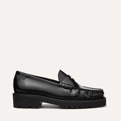 The Louisa Loafer in Black Calf, a leather penny loafer with chunky lug sole, featuring high-shine abrasivato leather and a lightweight design.