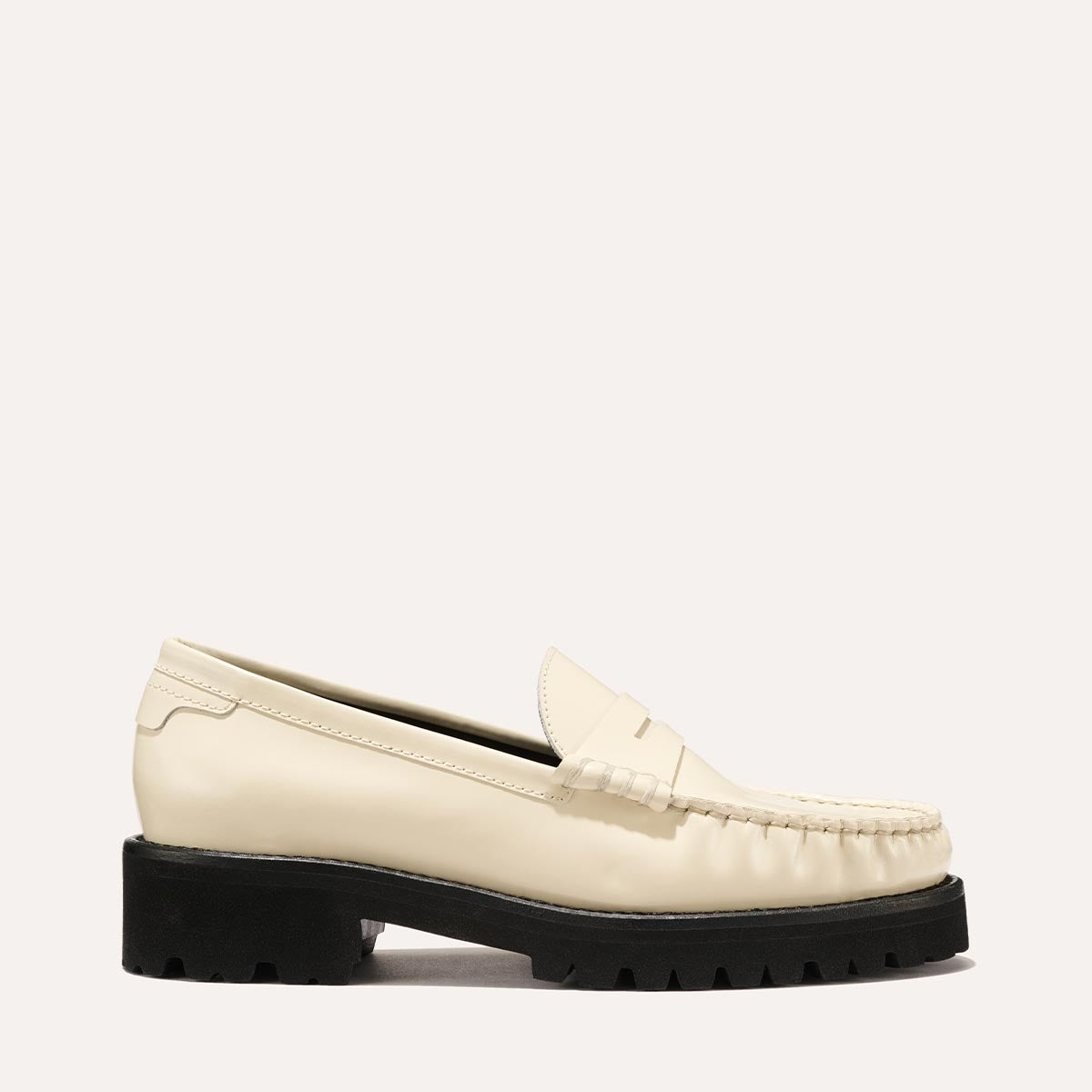 The Louisa Loafer in Cream Calf, a leather penny loafer with chunky lug sole, featuring high-shine abrasivato leather and a lightweight design.