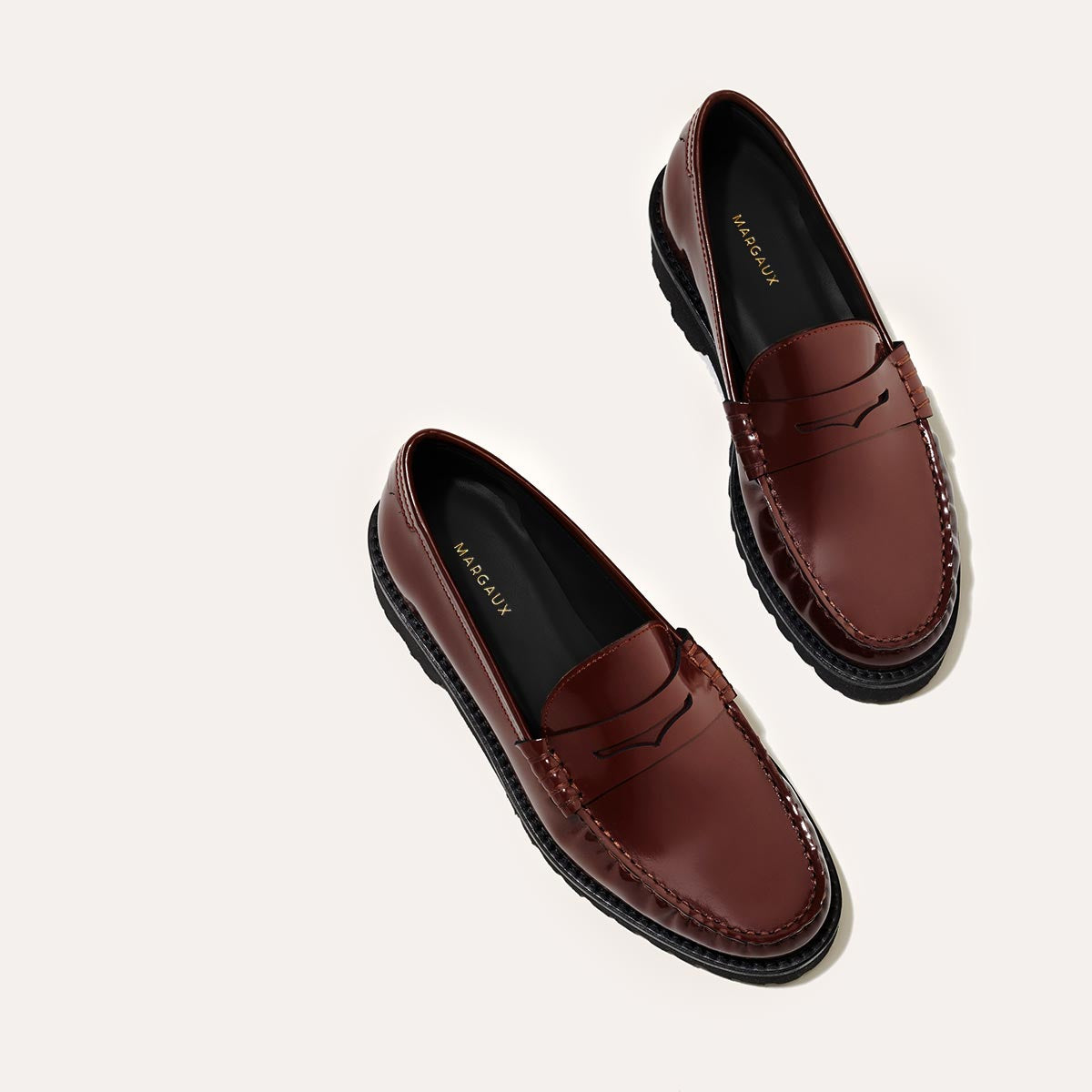 The Louisa Loafer in Hickory Calf, a leather penny loafer with chunky lug sole, featuring high-shine abrasivato leather and a lightweight design.