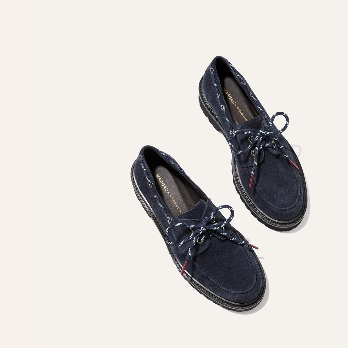 A pair of dark navy suede The Marine Loafer - Vintage Navy Suede boat-shoe loafers with rope-style laces and a lightweight lug sole.