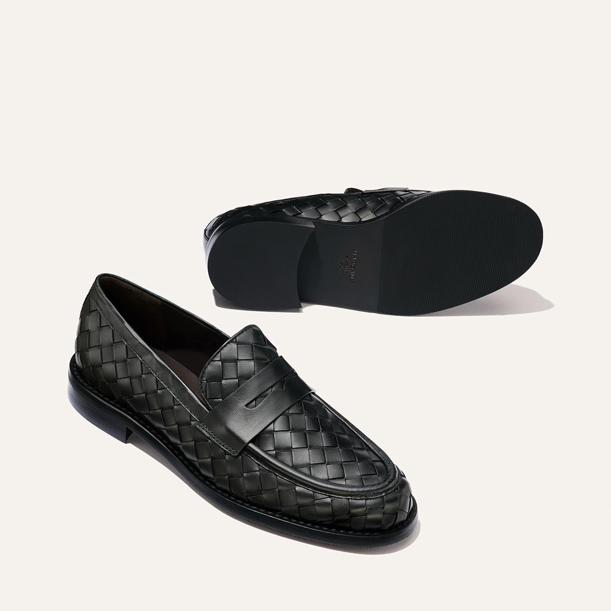 The Marlowe Loafer in Black Woven Pasado Calf by Margaux, a timeless wardrobe staple, is displayed from the side and bottom views against a plain white background.