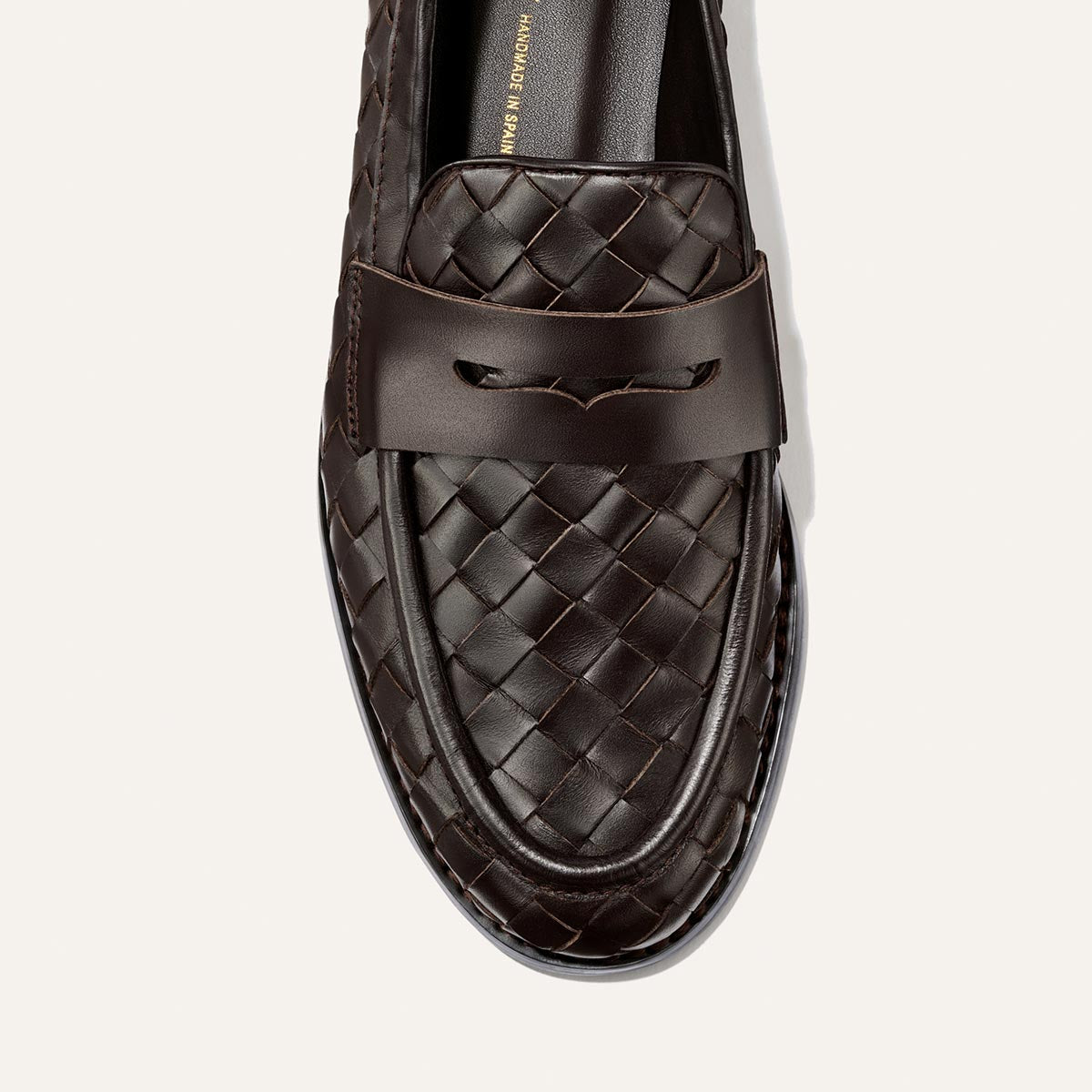 A close-up of The Marlowe Loafer in Brown Woven Pasado Calf by Margaux, featuring a dark brown woven leather design and a smooth leather band across the upper, displayed against a plain light background.