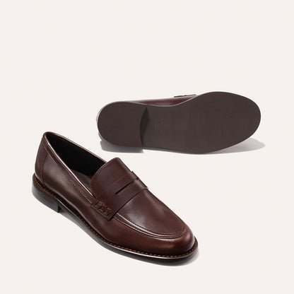 The Marlowe Loafer - Mahogany Calf by Margaux, shown with one shoe upright to highlight the top and side, and the other on its side displaying the sole.