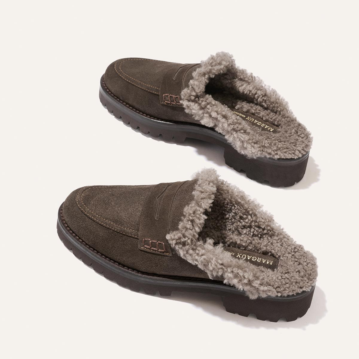 Margaux The Marlowe Mule in English brown suede, lined with cozy grey shearling and featuring thick lug soles.