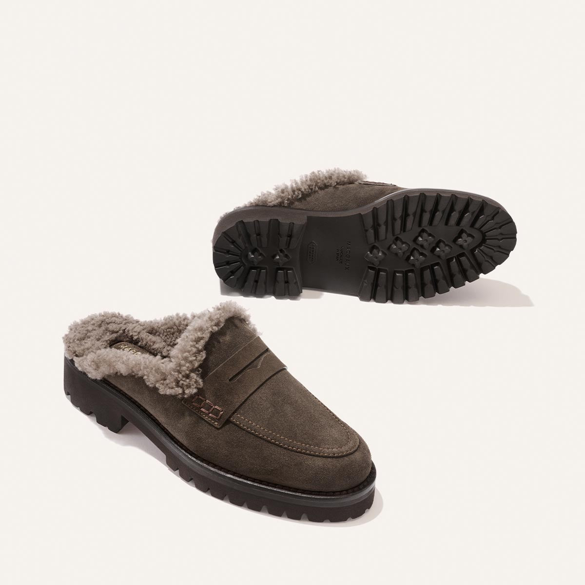 The Marlowe Mule in English Brown Suede and Shearling, shown from the side and bottom, featuring cozy shearling lining and thick lug soles.