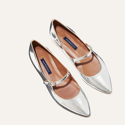 The Mary Jane in shiny Silver Mirror Patent, a ballet flat with a pointed toe and an adjustable strap for a secure fit.