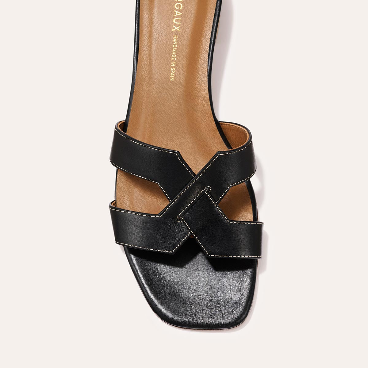 The MX 35 - Black Calf by Margaux-development is a black leather sandal with wide X-shaped straps, a tan insole, square open toe, and a comfortable walkable heel for all-day style.