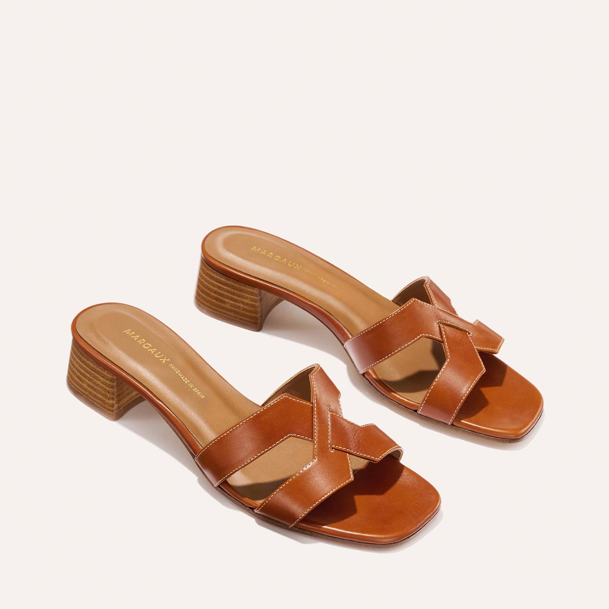 The MX 35 - Saddle Calf by Margaux-development: brown leather sandals with open toes, woven straps, 1.5-inch block heels, and tan insoles.