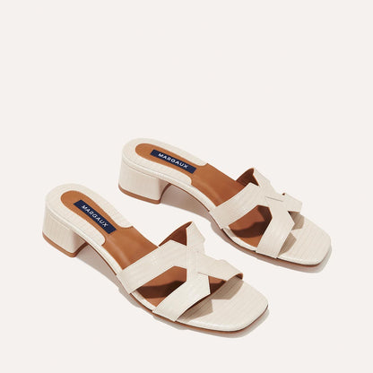 The MX 35 in Ecru Lizard, a slip-on sandal with structured straps, a subtly square toe and a comfortable 1.5-inch block heel.