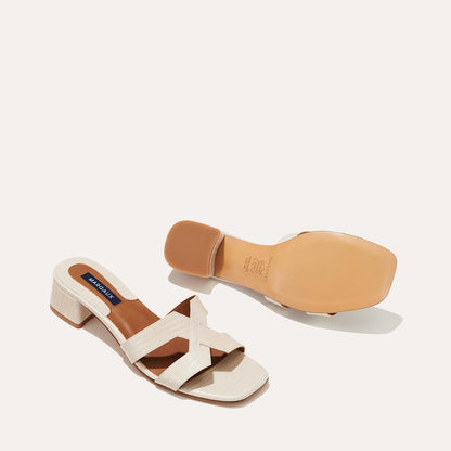 The MX 35 in Ecru Lizard, a slip-on sandal with structured straps, a subtly square toe and a comfortable 1.5-inch block heel.