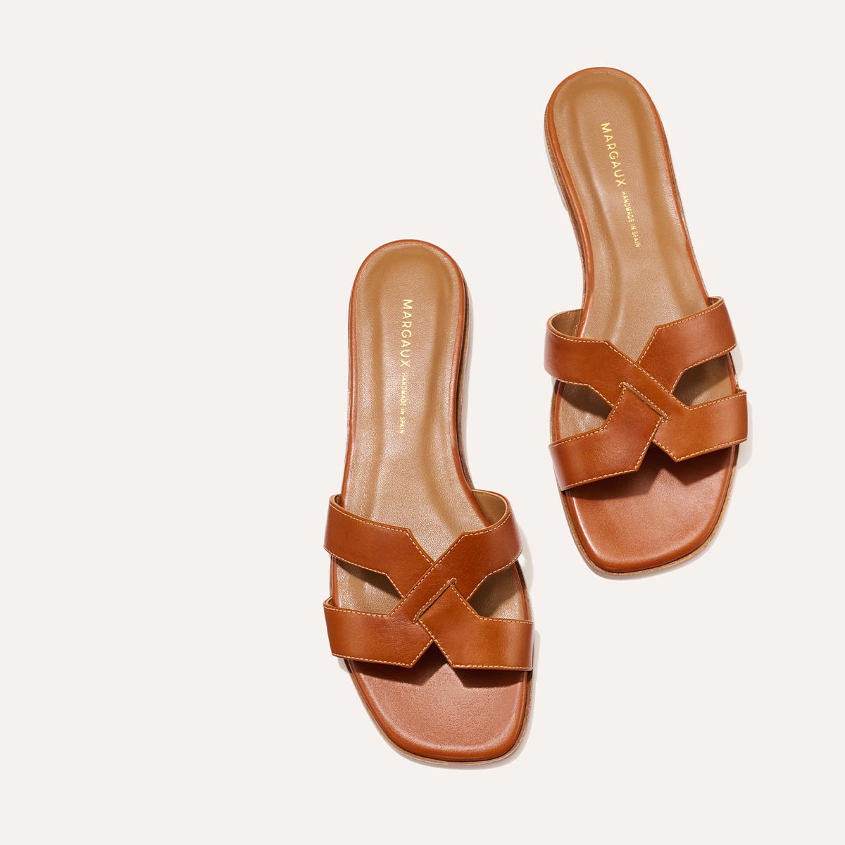 The MX Sandal in smooth saddle nappa leather, a slip-on sandal featuring embossed Italian leather with structured straps and a subtly square toe.