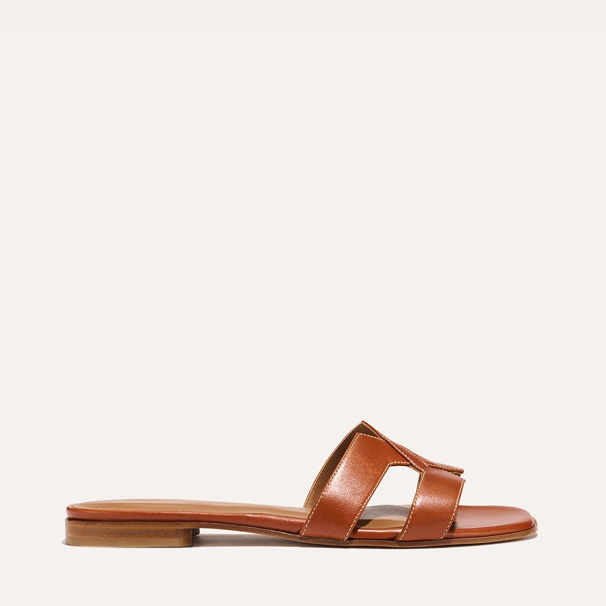 The MX Sandal in smooth saddle nappa leather, a slip-on sandal featuring embossed Italian leather with structured straps and a subtly square toe.