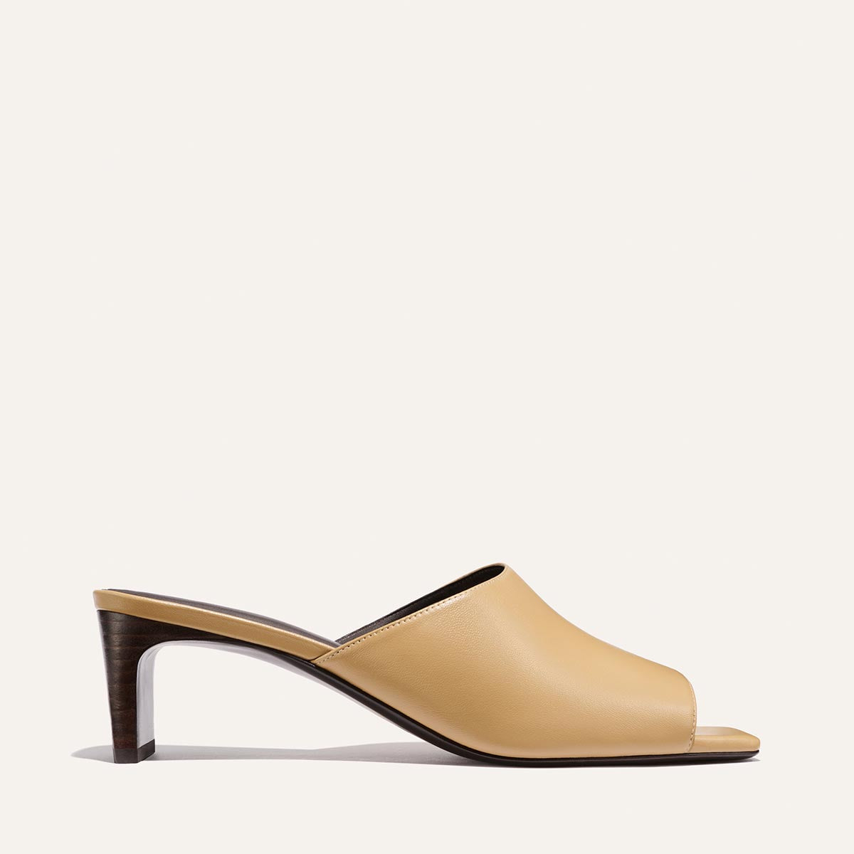Beige sandal with a wooden heel on a white background