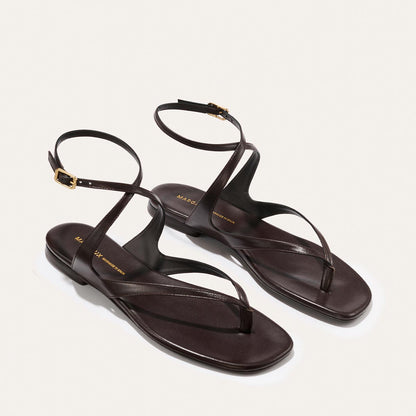 Pair of espresso nappa sandals on a light gray background