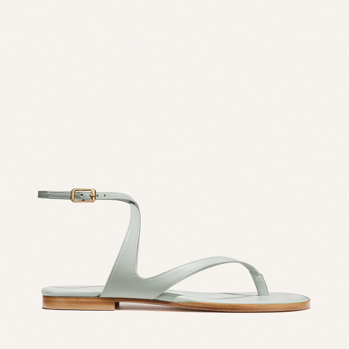 The Palermo Sandal - Sky Nappa light blue leather thong sandals featuring an ankle strap, gold buckle, and cushioned insole.